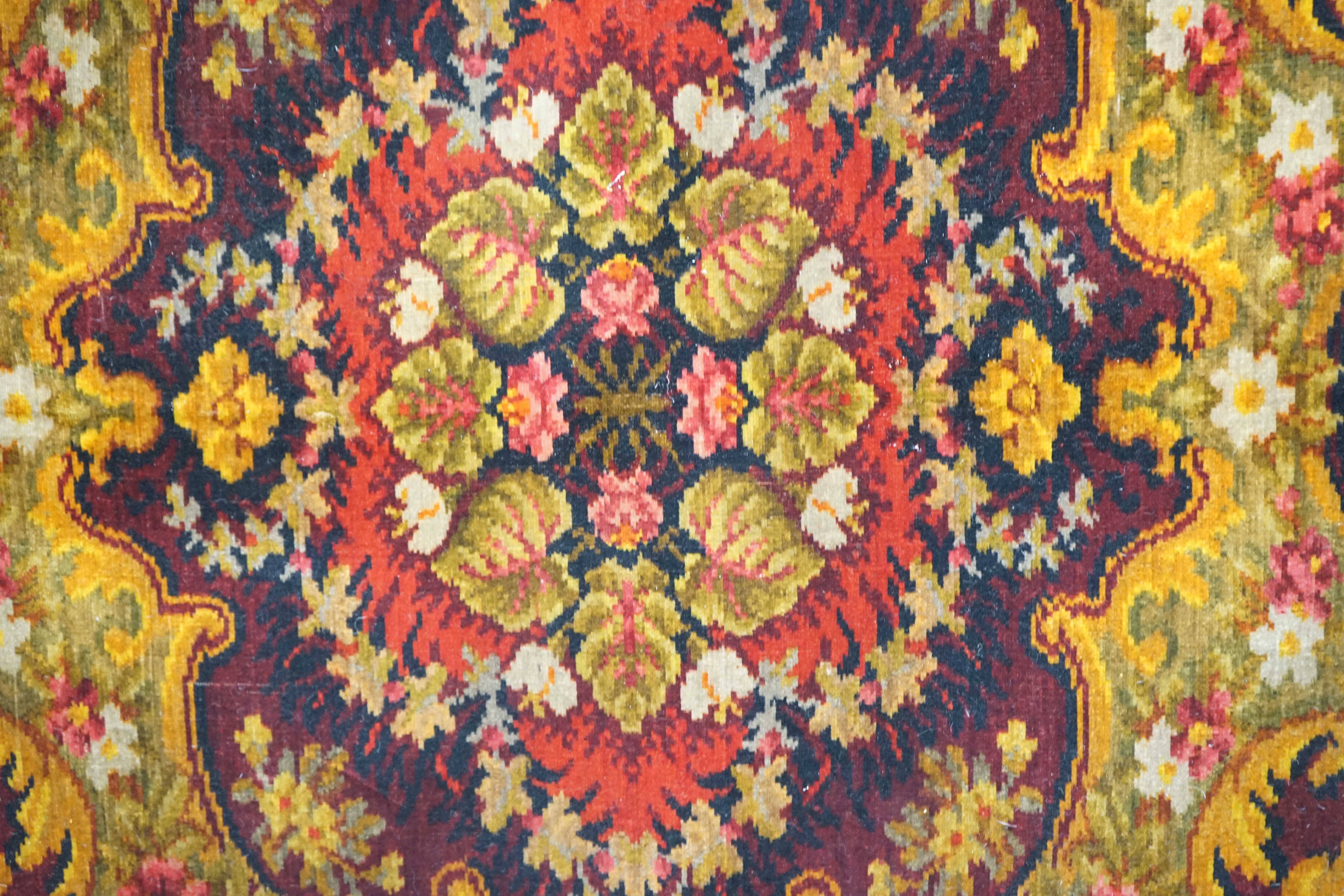An Edwardian table cover in brightly coloured wools in a floral design, together with a later 20th century continental grey, beige and cream patterned silk cover, Edwardian table cover 220cm x 172cm. Condition - colours